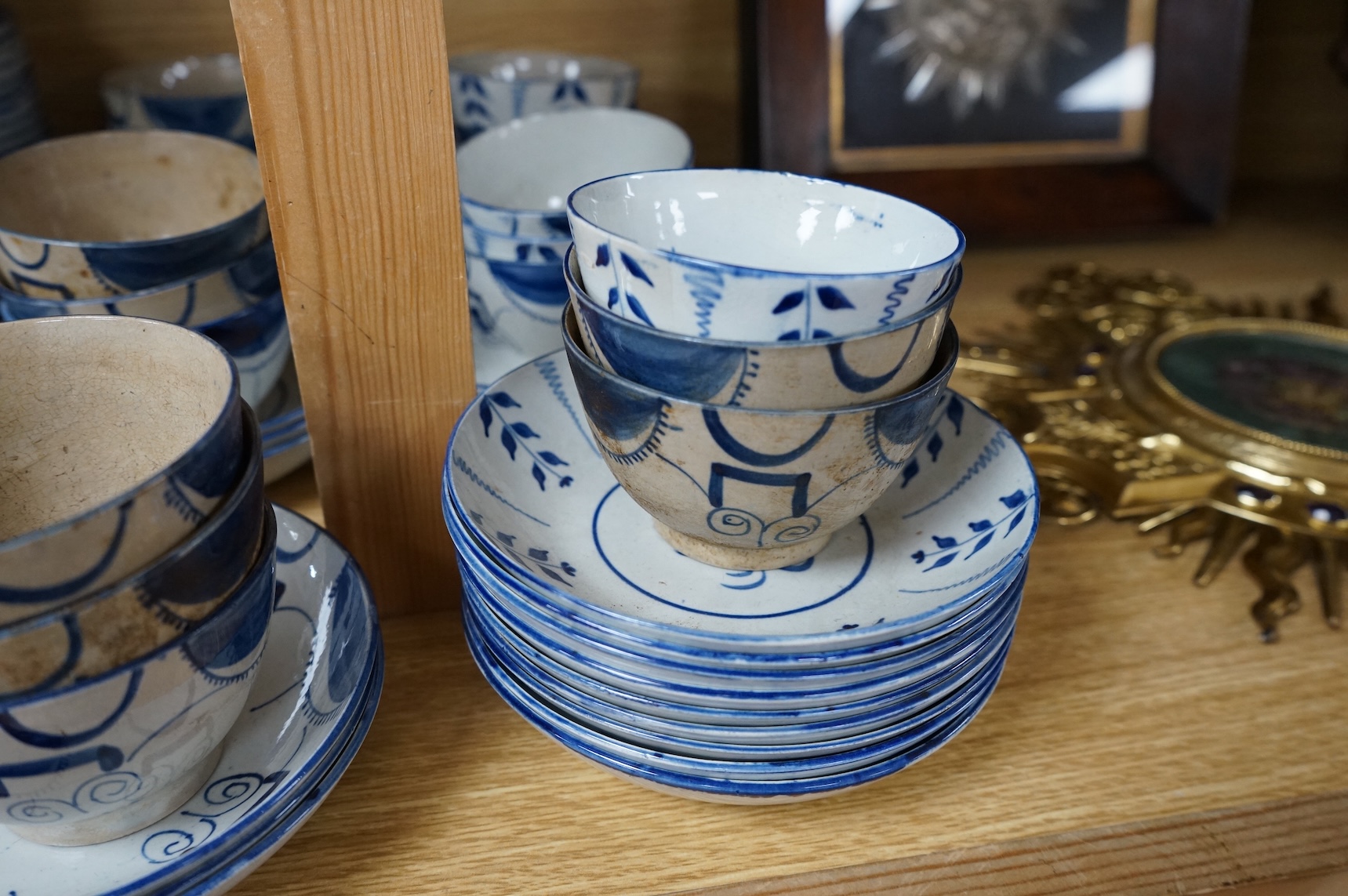 A group of 19th century pearlware set of tea bowls and saucers and to similar basket with border plates